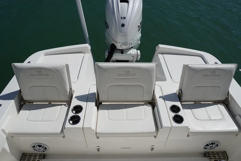Slide: The Image of 2024 Regulator 26XO boat seats with cup holders and Yamaha V8 engine. - 43