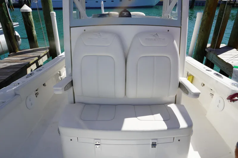 Slide: The Image of 2024 Regulator 26XO boat seating with white cushioned seats and armrests. - 44