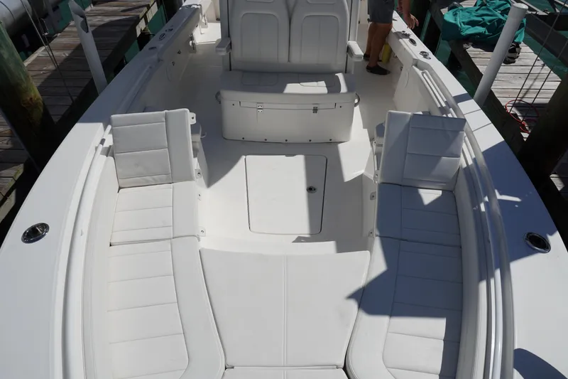 Slide: The Image of 2024 Regulator 26XO boat interior with white seating and spacious deck layout. - 50