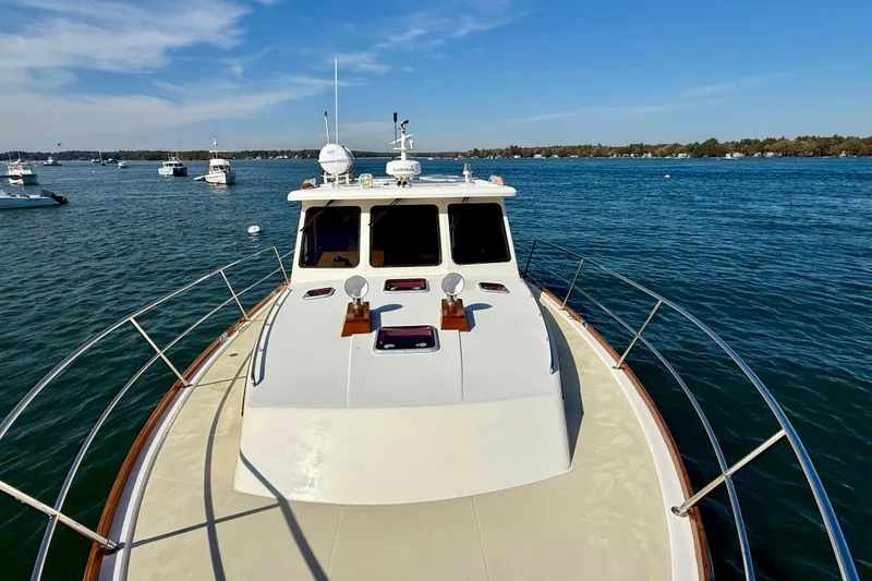 Slide: The Image of 2006 Sabre 42 Sedan yacht on calm water, surrounded by other boats. - 11