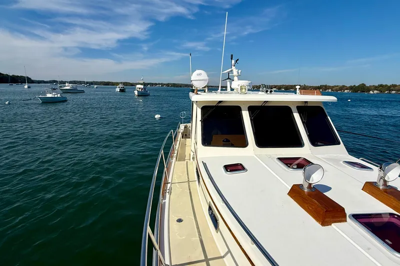 Slide: The Image of 2006 Sabre 42 Sedan yacht on calm blue waters under a clear sky. - 14