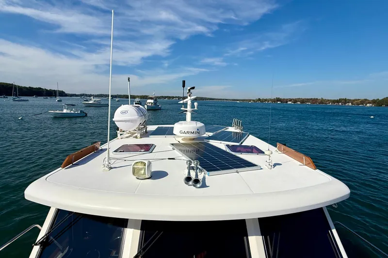 Slide: The Image of 2006 Sabre 42 Sedan yacht on serene blue waters under a clear sky. - 15