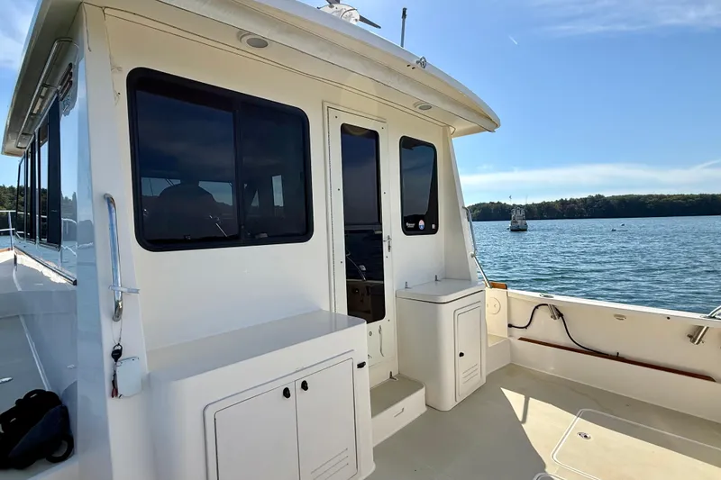 Slide: The Image of 2006 Sabre 42 Sedan yacht on calm waters, featuring sleek design and spacious deck. - 22