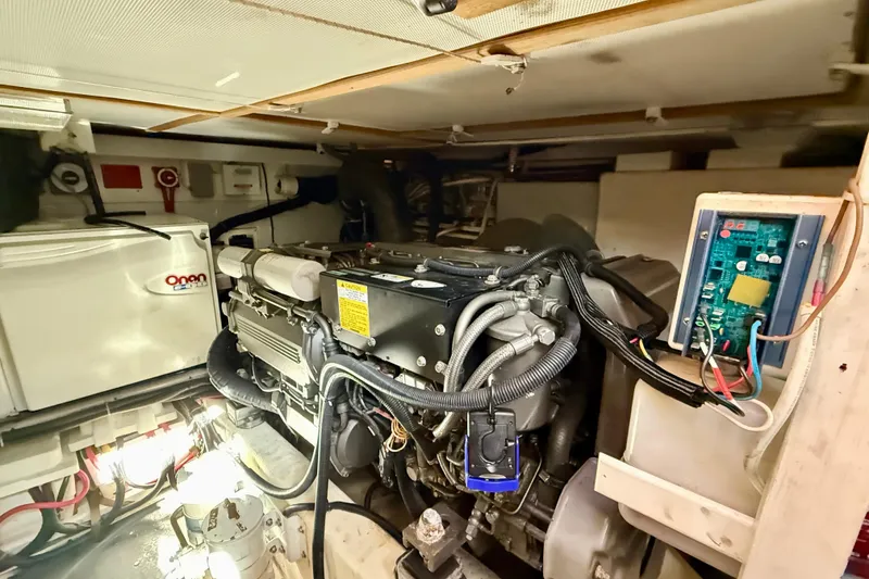 Slide: The Image of Engine room of a 2006 Sabre 42 Sedan with Onan generator and wiring components. - 26