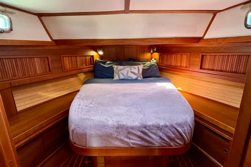 Slide: The Image of Cozy cabin bedroom in 2006 Sabre 42 Sedan yacht with wooden interior and soft bedding. - 30