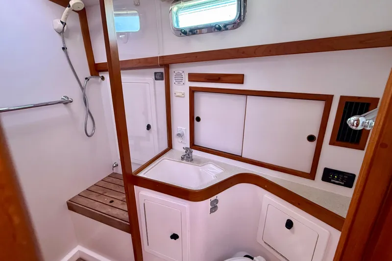 Slide: The Image of 2006 Sabre 42 Sedan bathroom with wooden accents, shower, and sink. - 32