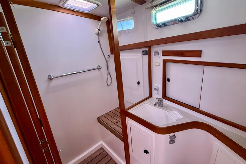 Slide: The Image of 2006 Sabre 42 Sedan bathroom with wooden accents, shower, and sink. - 33