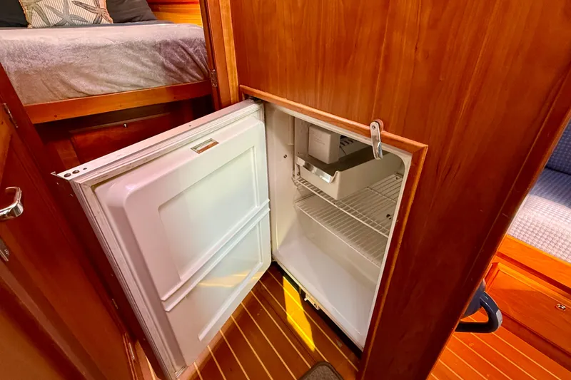 Slide: The Image of Open refrigerator in 2006 Sabre 42 Sedan yacht interior with wooden cabinetry. - 35