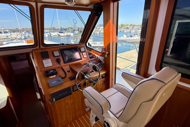 Slide: The Image of Interior of 2006 Sabre 42 Sedan yacht with helm station and marina view. - 44