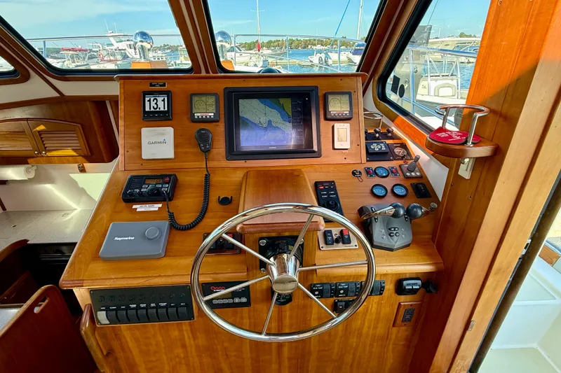 Slide: The Image of 2006 Sabre 42 Sedan helm with navigation controls, steering wheel, and marine electronics. - 45