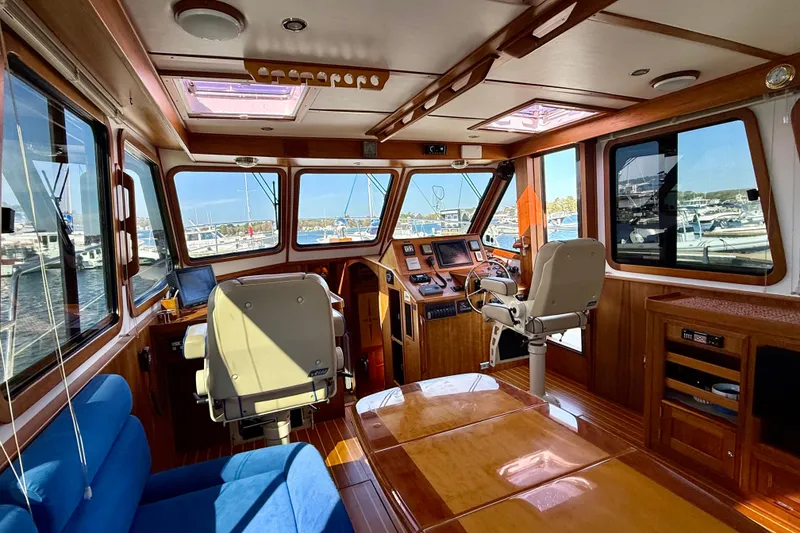 Slide: The Image of Interior of 2006 Sabre 42 Sedan yacht with wooden finishes and marina view. - 47