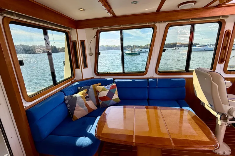 Slide: The Image of Interior of 2006 Sabre 42 Sedan yacht with blue seating and scenic water view. - 48