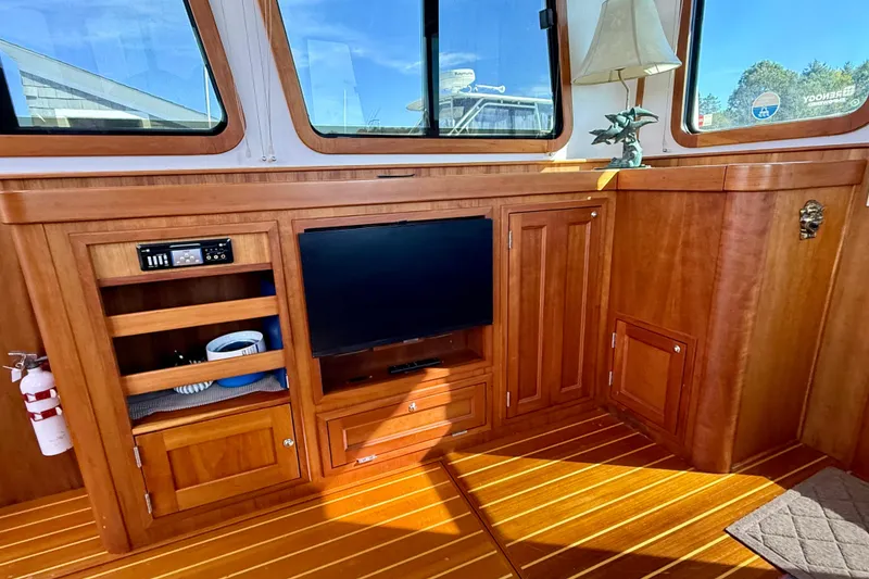 Slide: The Image of Interior of 2006 Sabre 42 Sedan with wooden cabinetry and entertainment setup. - 50