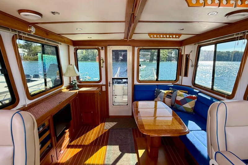 Slide: The Image of Interior of 2006 Sabre 42 Sedan yacht with blue seating and wooden accents. - 51