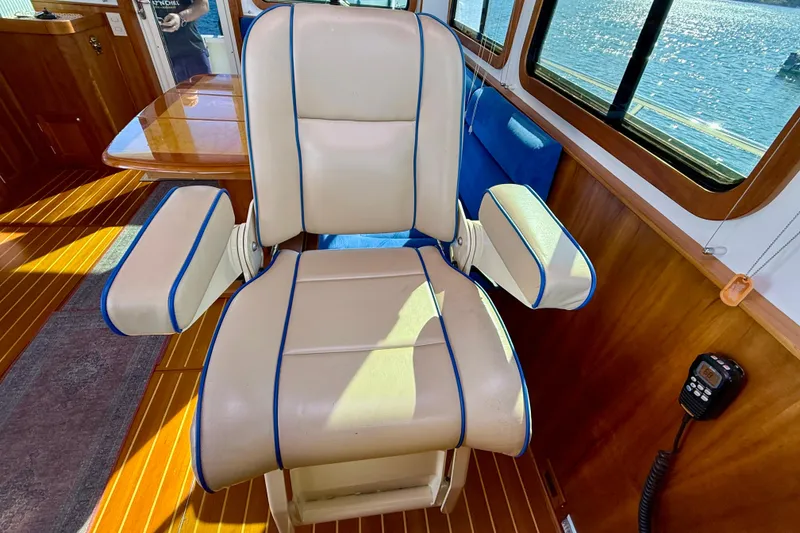 Slide: The Image of Captain's chair in 2006 Sabre 42 Sedan yacht interior, with wood flooring and ocean view. - 53