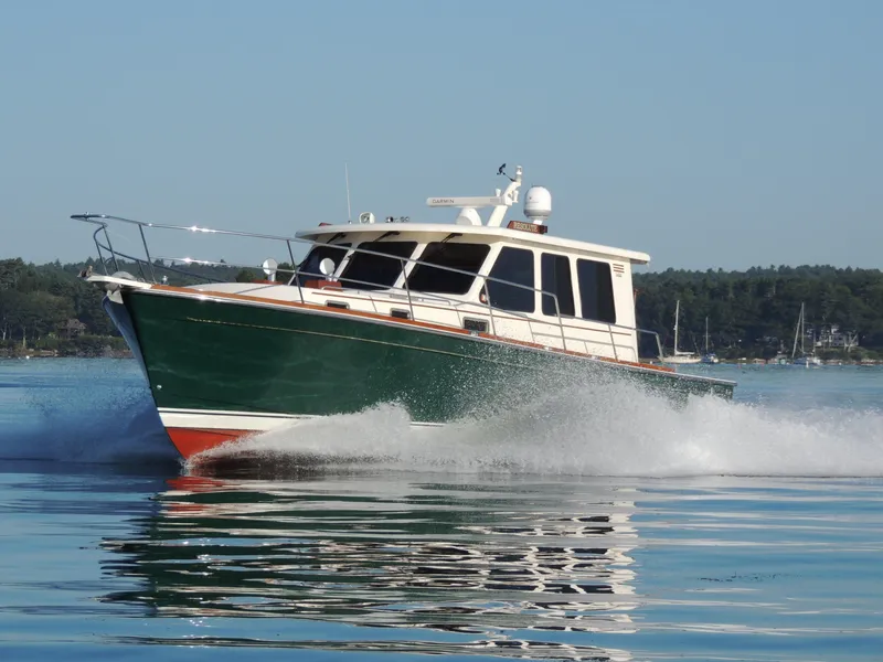 Slide: The Image of 2006 Sabre 42 Sedan cruising on calm water, showcasing sleek design and performance. - 9