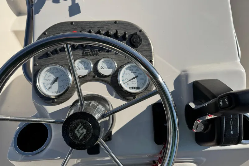 Slide: The Image of Steering console of 2026 Carolina Skiff 19 LS boat with gauges and controls. - 4