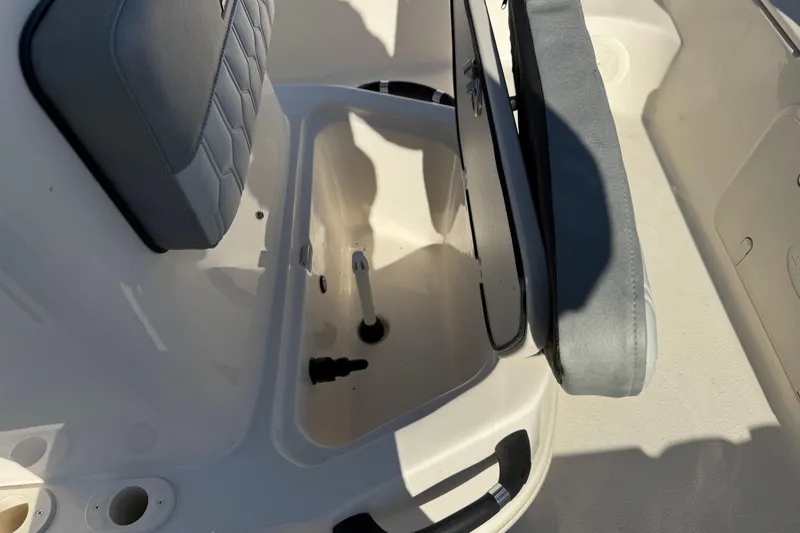 Slide: The Image of 2026 Carolina Skiff 19 LS boat seat with storage compartment open. - 9
