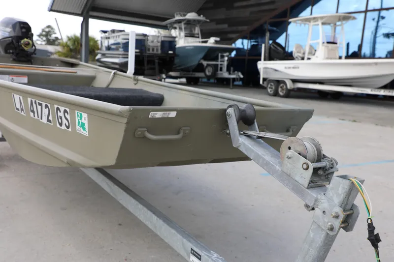 Slide: The Image of 2025 Tracker Grizzly 1436 Jon boat on trailer at dealership. - 10