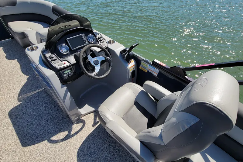 Slide: The Image of 2023 Veranda Relax VR20RC boat interior with steering wheel and seating on water. - 5