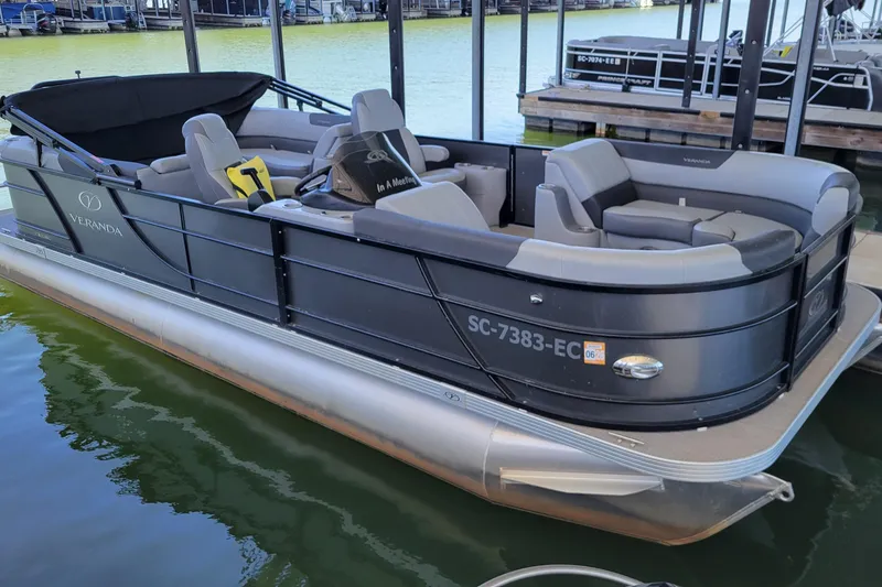 The Image of 2023 Veranda Relax VR22RC pontoon boat docked on calm water. - 0