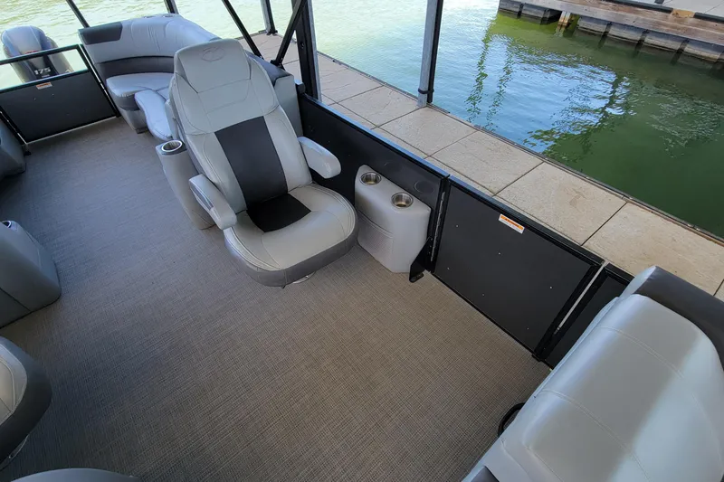 Slide: The Image of 2023 Veranda Relax VR22RC pontoon boat interior with plush seating and cup holders. - 10