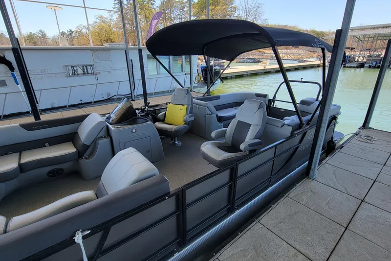 Slide: The Image of 2023 Veranda Relax VR22RC pontoon boat docked, featuring spacious seating and canopy. - 4