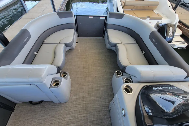 Slide: The Image of 2023 Veranda Relax VR22RC pontoon boat interior with plush seating and cup holders. - 5