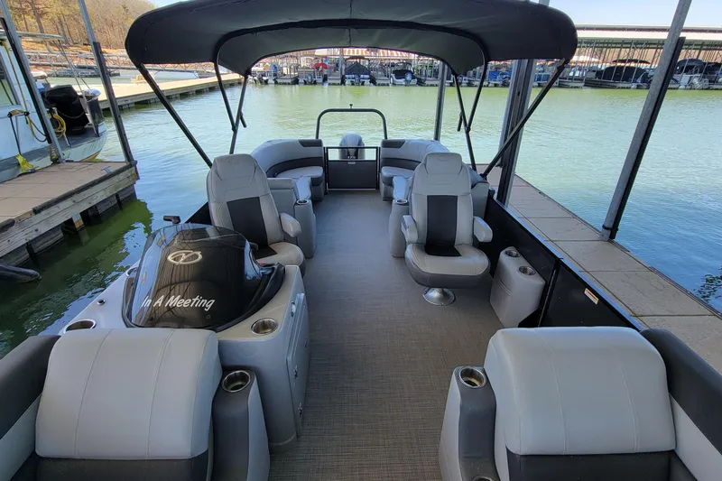 Slide: The Image of 2023 Veranda Relax VR22RC pontoon boat interior with seating and canopy at dock. - 6