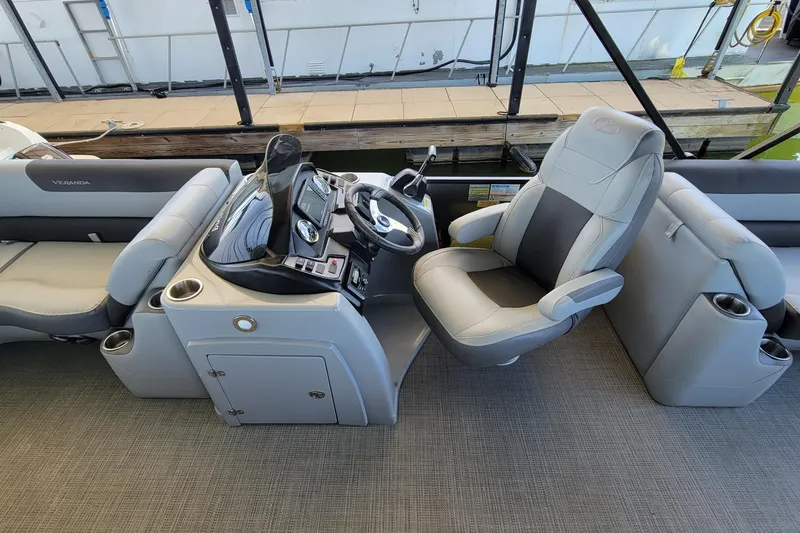 Slide: The Image of 2023 Veranda Relax VR22RC boat interior with steering console and comfortable seating. - 8