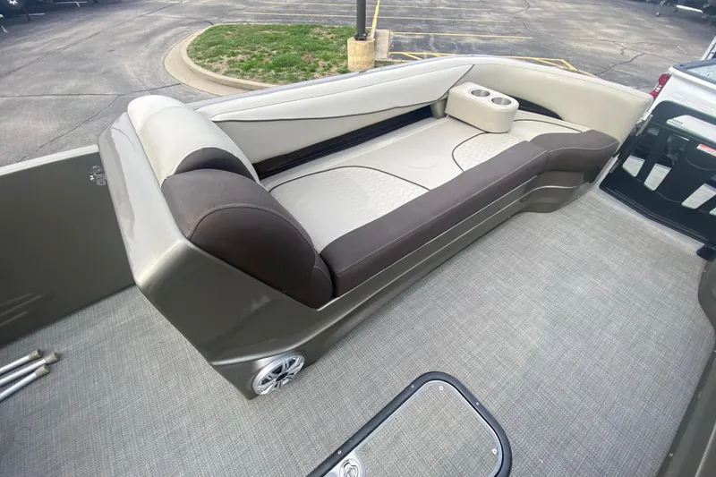 Slide: The Image of 2016 Manitou 25 Legacy LT SHP boat interior with cushioned seating and cup holders. - 13