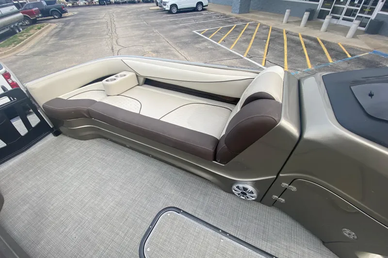 Slide: The Image of 2016 Manitou 25 Legacy LT SHP boat interior with beige and brown seating. - 14