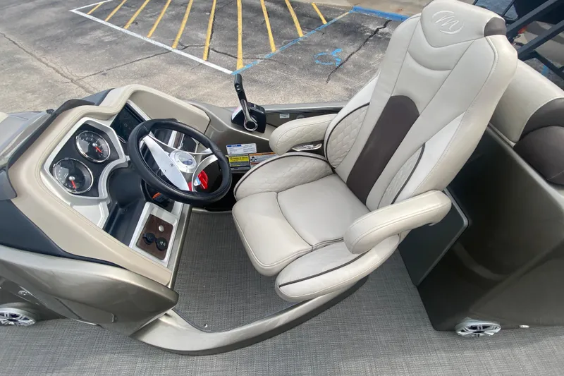 Slide: The Image of Captain's seat and dashboard of 2016 Manitou 25 Legacy LT SHP boat. - 20