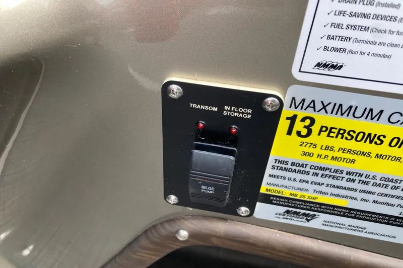 Slide: The Image of Control panel and capacity label on 2016 Manitou 25 Legacy LT SHP boat. - 26