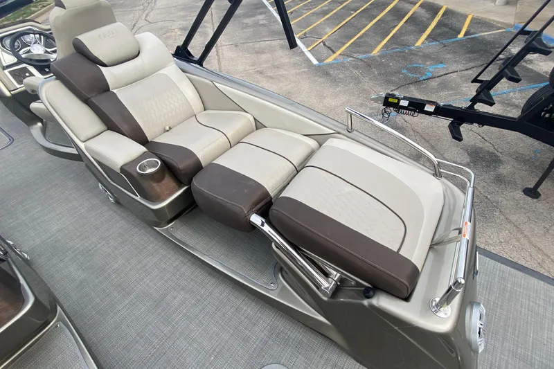 Slide: The Image of 2016 Manitou 25 Legacy LT SHP boat interior with luxurious seating and cup holder. - 29