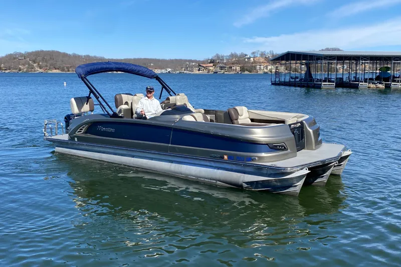 Slide: The Image of 2016 Manitou 25 Legacy LT SHP pontoon boat on a serene lake. - 3