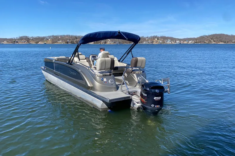 Slide: The Image of 2016 Manitou 25 Legacy LT SHP pontoon boat on a calm lake. - 9