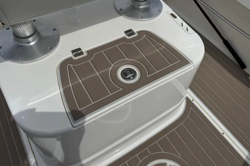 Slide: The Image of 2004 Boston Whaler 190 Nantucket boat deck with storage compartment and seating. - 13