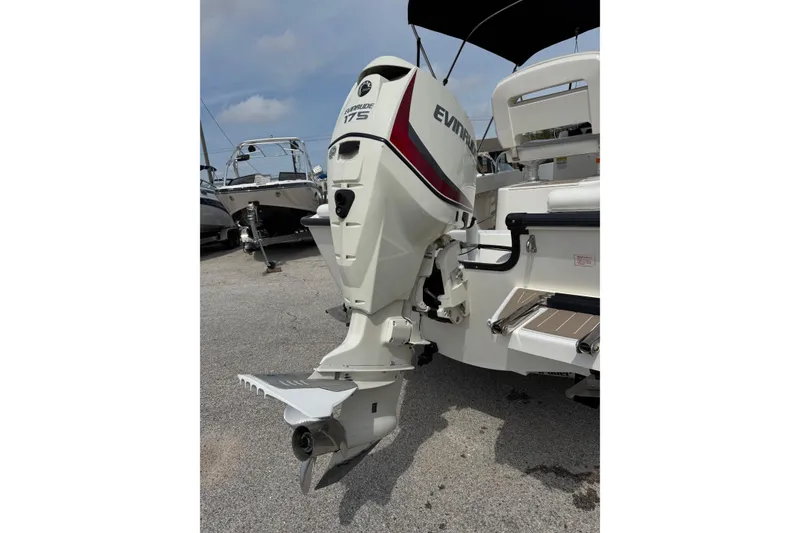 Slide: The Image of 2004 Boston Whaler 190 Nantucket with Evinrude 175 outboard motor, docked on pavement. - 18