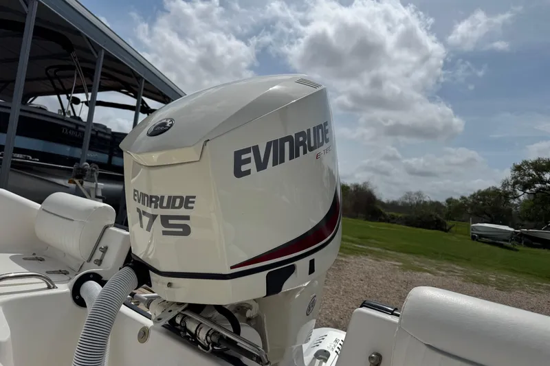 Slide: The Image of 2004 Boston Whaler 190 Nantucket with Evinrude 175 outboard motor, parked outdoors. - 22