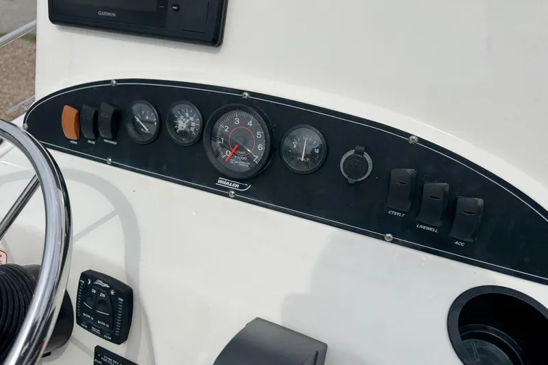 Slide: The Image of Dashboard of a 2004 Boston Whaler 190 Nantucket boat with gauges and controls. - 5