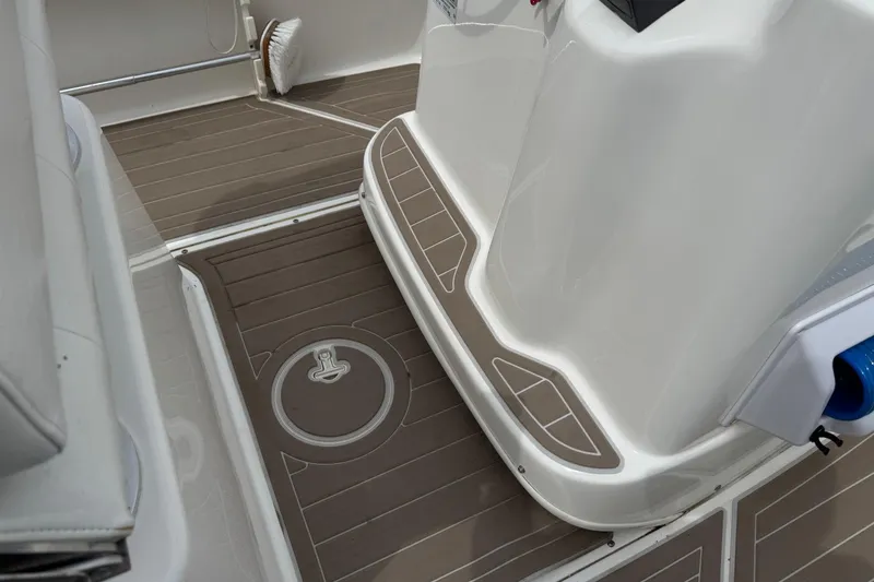 Slide: The Image of 2004 Boston Whaler 190 Nantucket boat interior with brown deck flooring. - 8