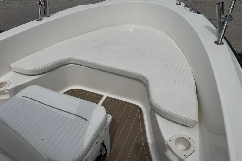Slide: The Image of 2004 Boston Whaler 190 Nantucket boat interior with white seating and deck. - 9