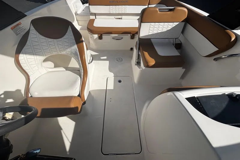 Slide: The Image of 2021 Bayliner VR6 Bowrider OB interior with brown and white seating arrangement. - 3