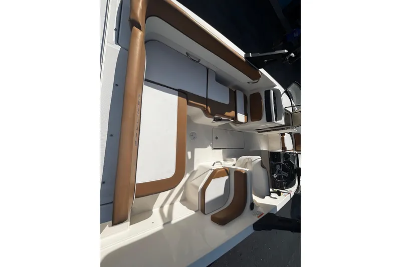 Slide: The Image of 2021 Bayliner VR6 Bowrider OB interior with brown and white seating arrangement. - 4