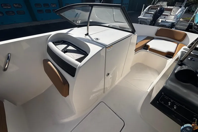 Slide: The Image of 2021 Bayliner VR6 Bowrider OB interior with seating and storage compartments. - 5