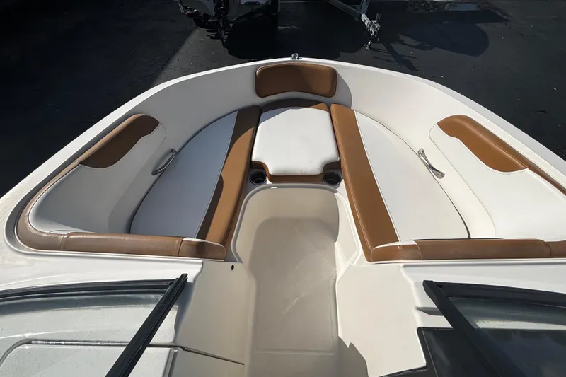 Slide: The Image of 2021 Bayliner VR6 Bowrider OB interior with tan and white seating. - 6