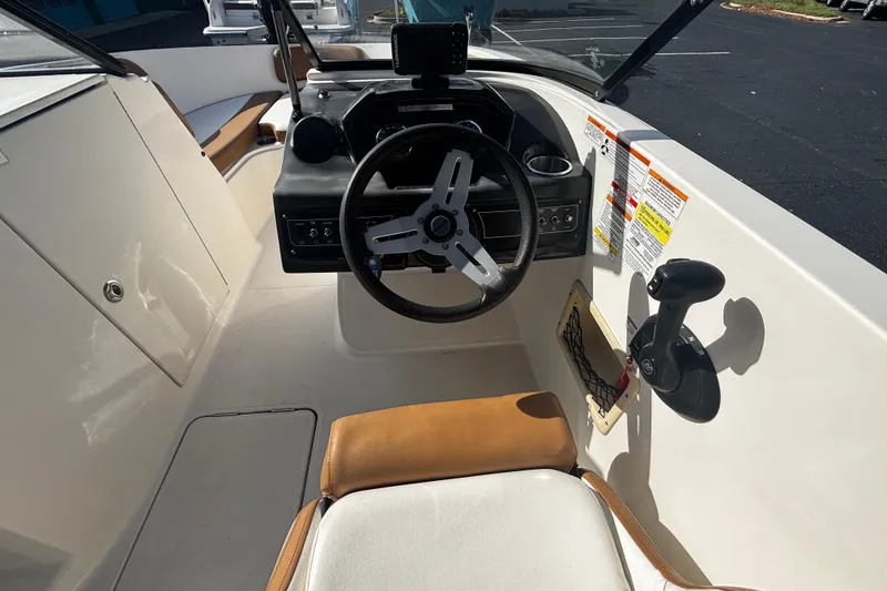 Slide: The Image of 2021 Bayliner VR6 Bowrider OB cockpit with steering wheel and controls. - 7
