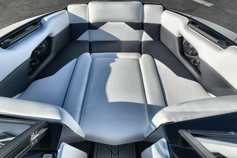 Slide: The Image of 2026 Moomba Mojo boat interior with sleek, modern seating and integrated speakers. - 11