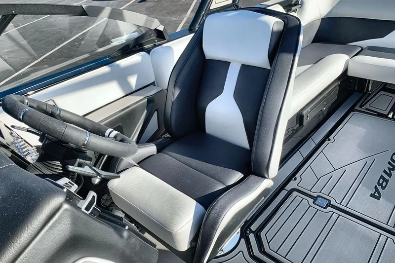 Slide: The Image of 2026 Moomba Mojo boat interior with sleek black and white seating and modern steering wheel. - 13